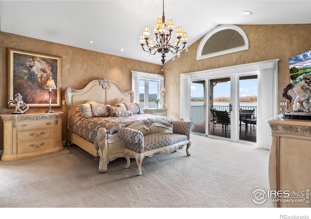 bedroom with access to outside, a water view, high vaulted ceiling, an inviting chandelier, and light colored carpet