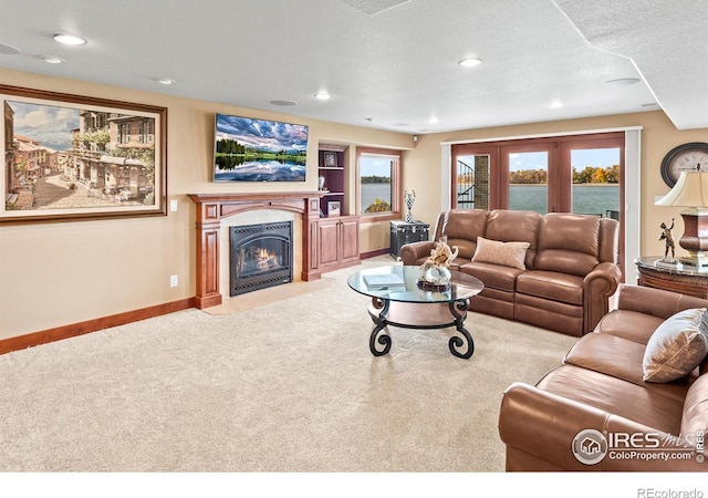 carpeted living room featuring a textured ceiling