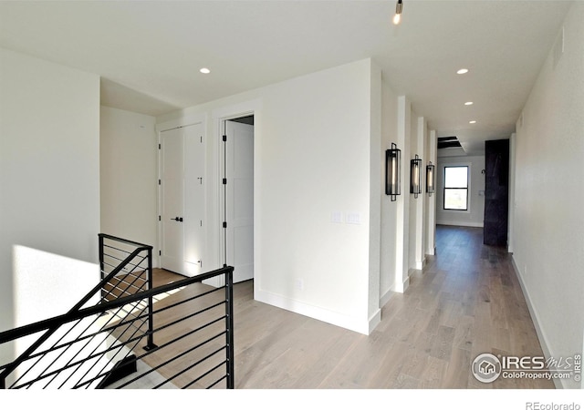 corridor with light hardwood / wood-style flooring