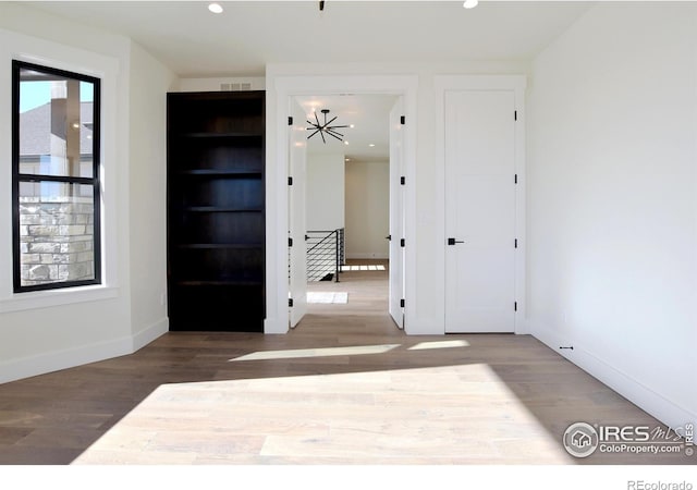 unfurnished room with hardwood / wood-style flooring