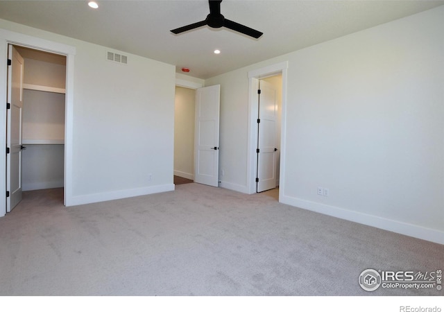 unfurnished bedroom featuring ceiling fan and light carpet