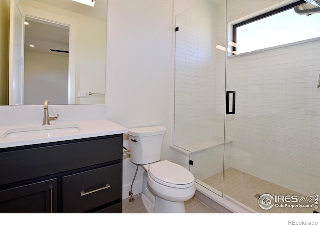 bathroom featuring an enclosed shower, vanity, toilet, and tile patterned floors