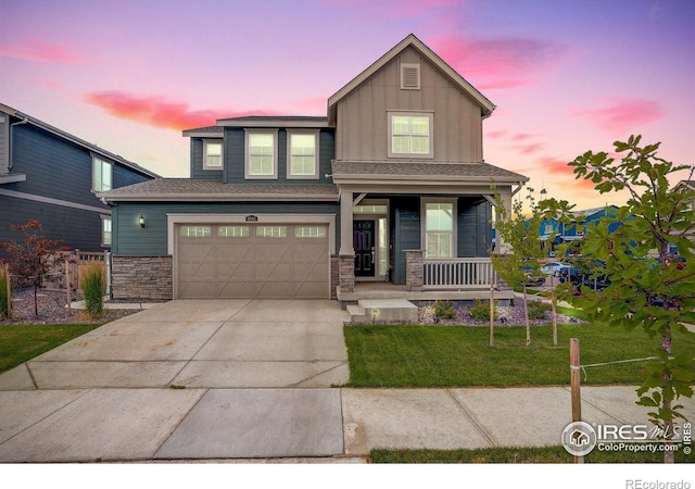 view of front of house with a porch, a garage, and a lawn