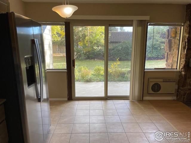 3345 Chisholm Trl Unit 105C, Boulder, CO 80301 - doorway to outside with light tile patterned floors and baseboards