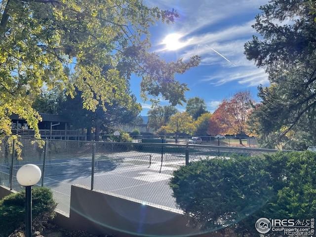 3345 Chisholm Trl Unit 105C, Boulder, CO 80301 - view of tennis court with view of wooded area