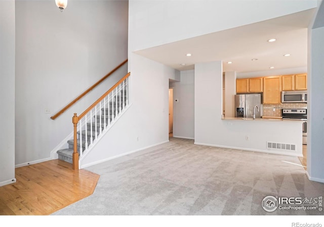 236 Remuda Ln, Lafayette, CO 80026 - unfurnished living room featuring stairway, baseboards, visible vents, and recessed lighting
