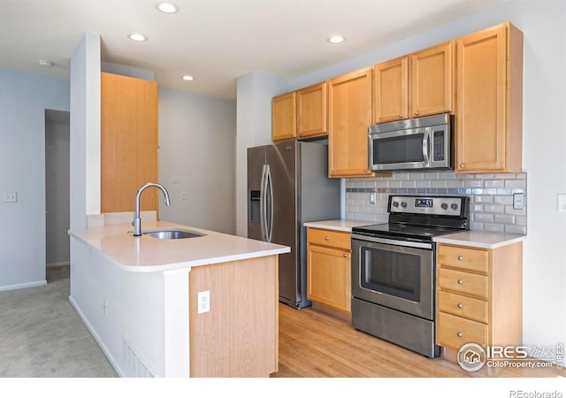 236 Remuda Ln, Lafayette, CO 80026 - kitchen with stainless steel appliances, a sink, recessed lighting, decorative backsplash, and light countertops