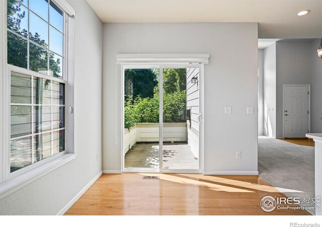 236 Remuda Ln, Lafayette, CO 80026 - doorway to outside featuring recessed lighting, wood finished floors, and baseboards