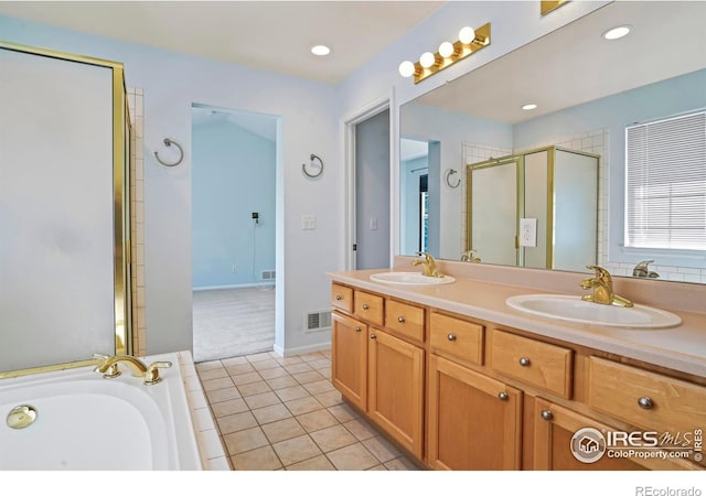 bathroom featuring vanity, tile patterned flooring, and plus walk in shower