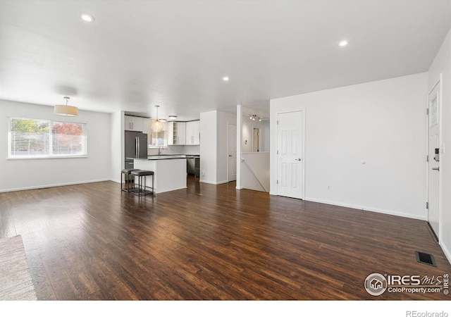 unfurnished living room featuring dark hardwood / wood-style flooring