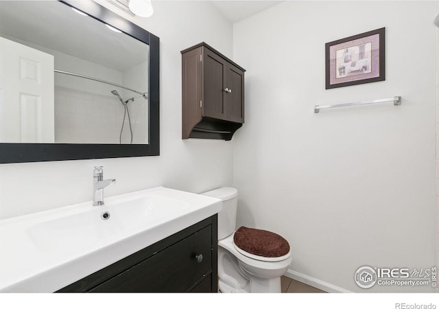 bathroom with vanity, toilet, tile patterned floors, and a shower