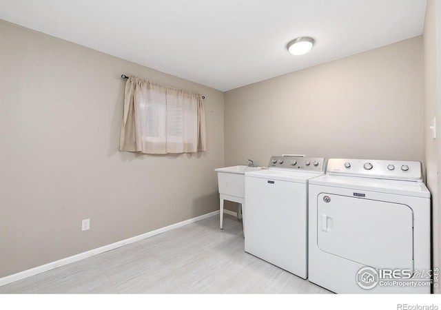 clothes washing area featuring separate washer and dryer