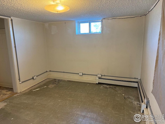 basement featuring a textured ceiling