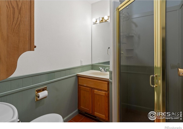 bathroom featuring vanity, a shower with shower door, and tile patterned flooring