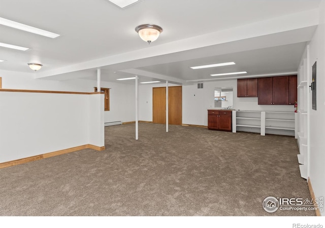 basement featuring carpet flooring and baseboard heating