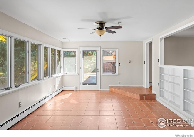 unfurnished sunroom with a baseboard heating unit and ceiling fan