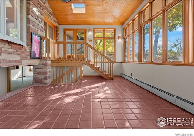 unfurnished sunroom featuring a baseboard radiator, a wealth of natural light, and wooden ceiling