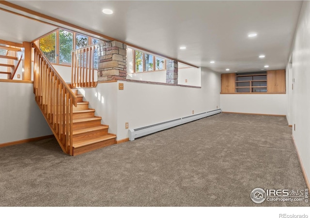 basement with carpet flooring and baseboard heating