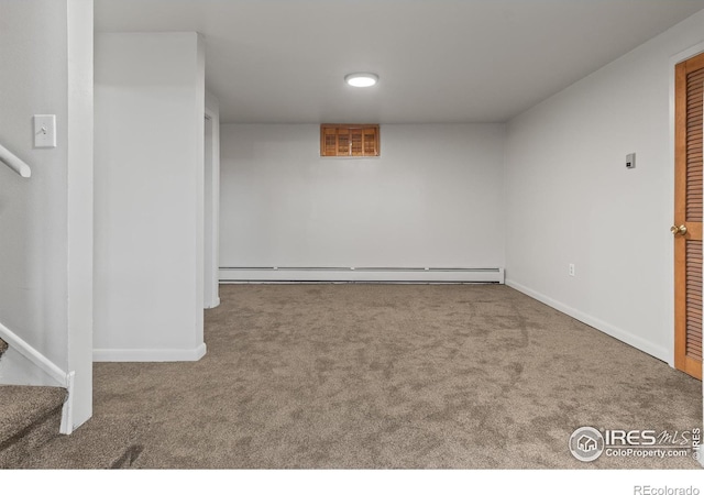 basement featuring baseboard heating and carpet flooring