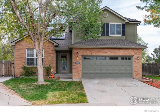 view of property with a front yard and a garage