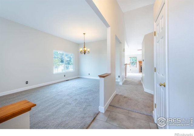 interior space with light carpet and a notable chandelier