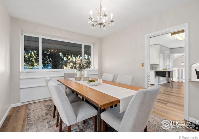 dining space featuring a chandelier and light hardwood / wood-style floors