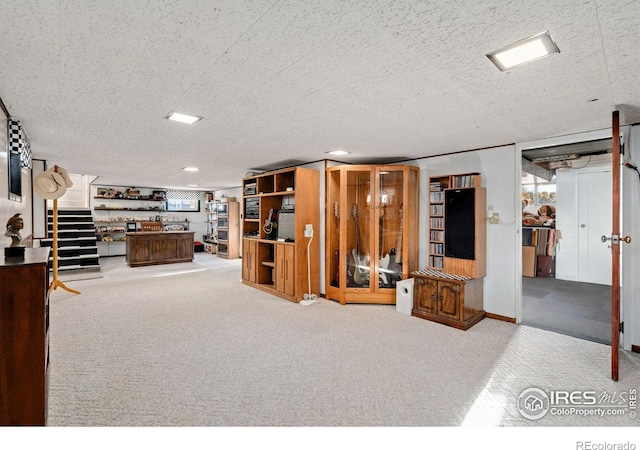 interior space featuring light carpet and a textured ceiling