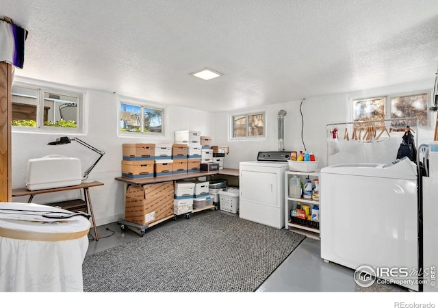 clothes washing area featuring washer and dryer and a textured ceiling