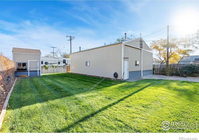 exterior space with a yard and an outbuilding