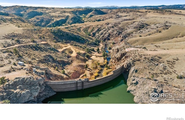 drone / aerial view featuring a water and mountain view