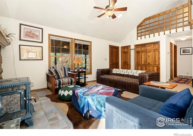 living room with ceiling fan, high vaulted ceiling, and a fireplace