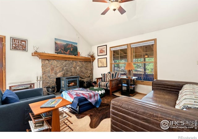 living room featuring carpet, high vaulted ceiling, a wood stove, and ceiling fan