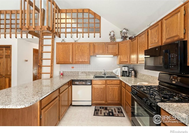 kitchen with kitchen peninsula, decorative backsplash, light stone countertops, black appliances, and sink