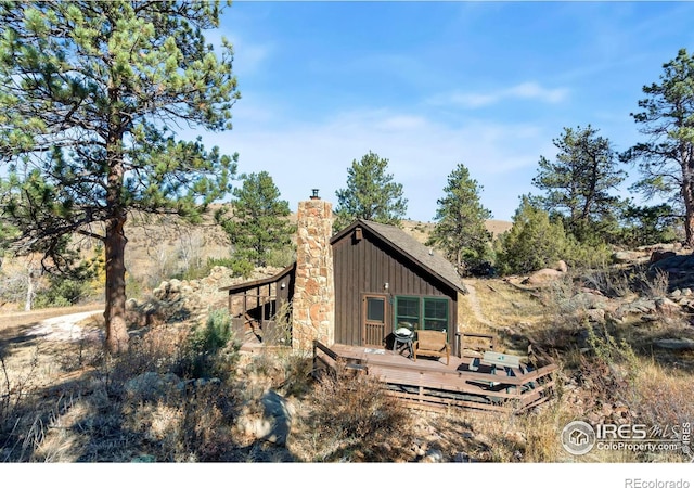 view of property exterior featuring a wooden deck