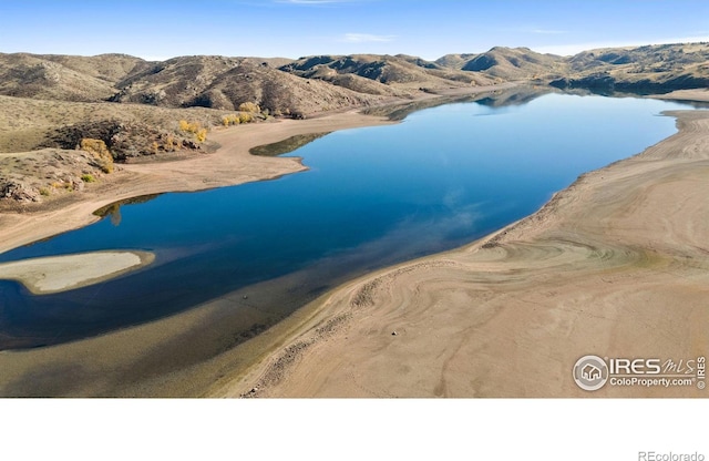 bird's eye view featuring a water and mountain view