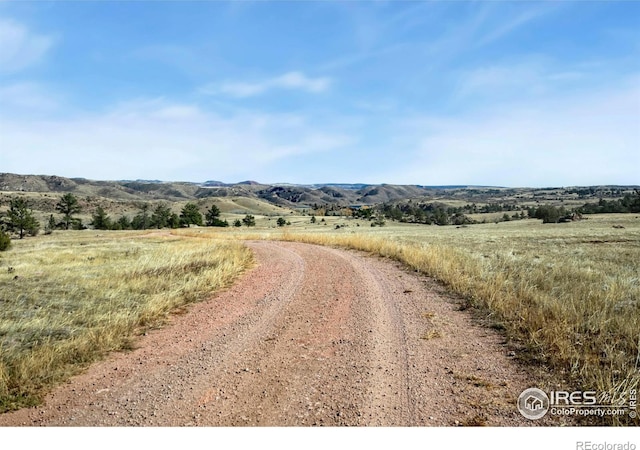 view of street with a mountain view and a rural view