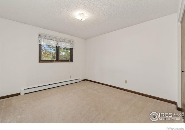 unfurnished room featuring light colored carpet, a textured ceiling, and baseboard heating