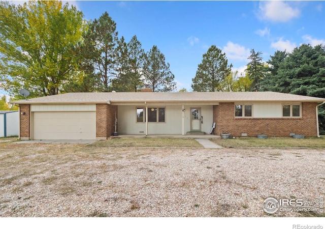 ranch-style house featuring brick siding, driveway, and an attached garage