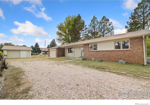 ranch-style house featuring a garage, driveway, brick siding, a chimney, and a front yard