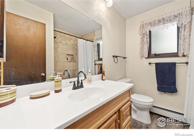 full bathroom with a baseboard heating unit, a shower with shower curtain, vanity, and toilet