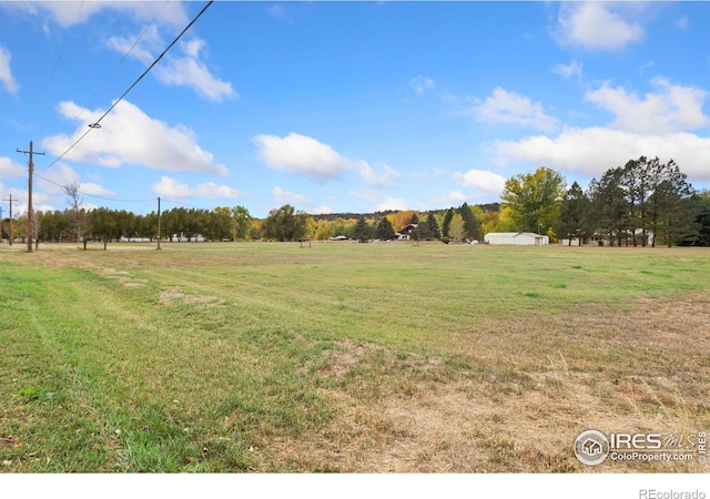 view of yard with a rural view