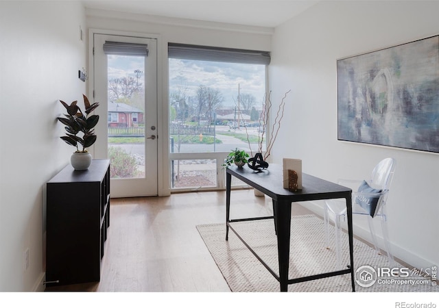 home office with light hardwood / wood-style floors