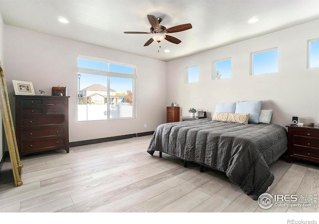 bedroom with light hardwood / wood-style floors and ceiling fan