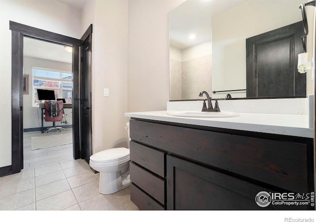 bathroom featuring tile patterned flooring, vanity, and toilet