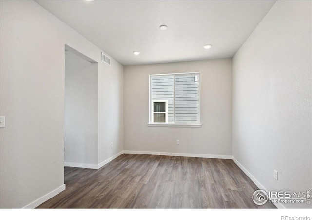 empty room featuring dark hardwood / wood-style flooring