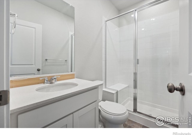 bathroom featuring vanity, toilet, and walk in shower