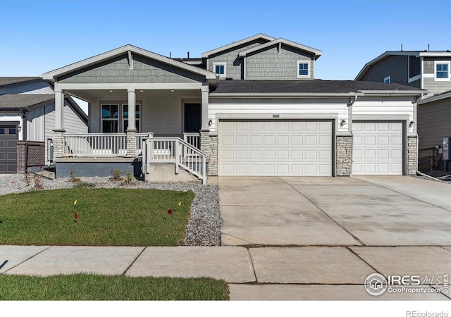 view of front of property with a porch and a garage