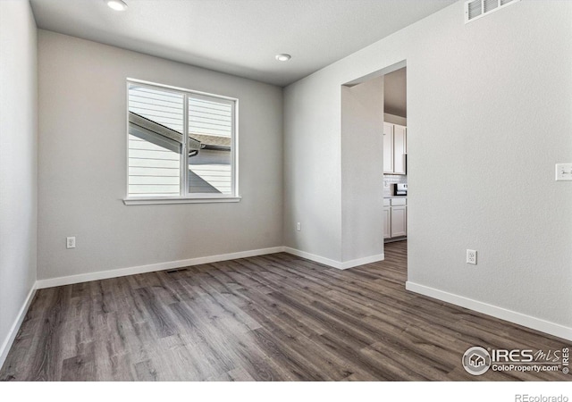 spare room featuring hardwood / wood-style floors