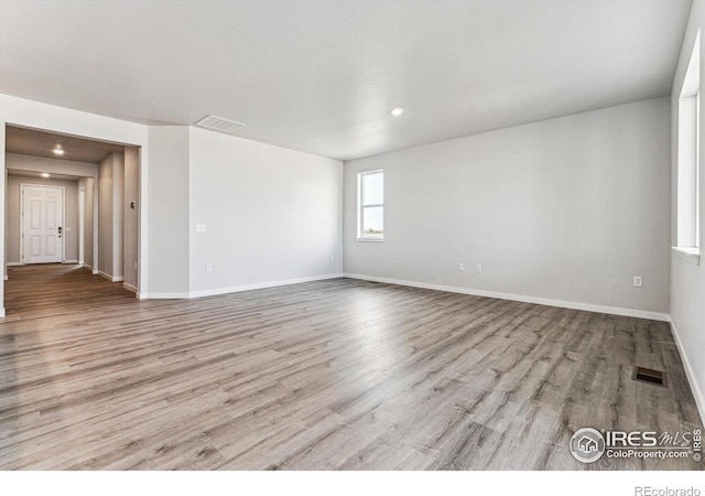 unfurnished room with light wood-type flooring