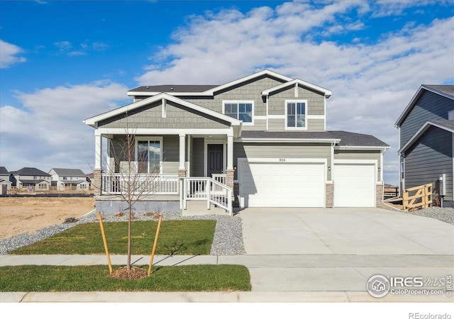 craftsman inspired home featuring a front yard, a porch, and a garage